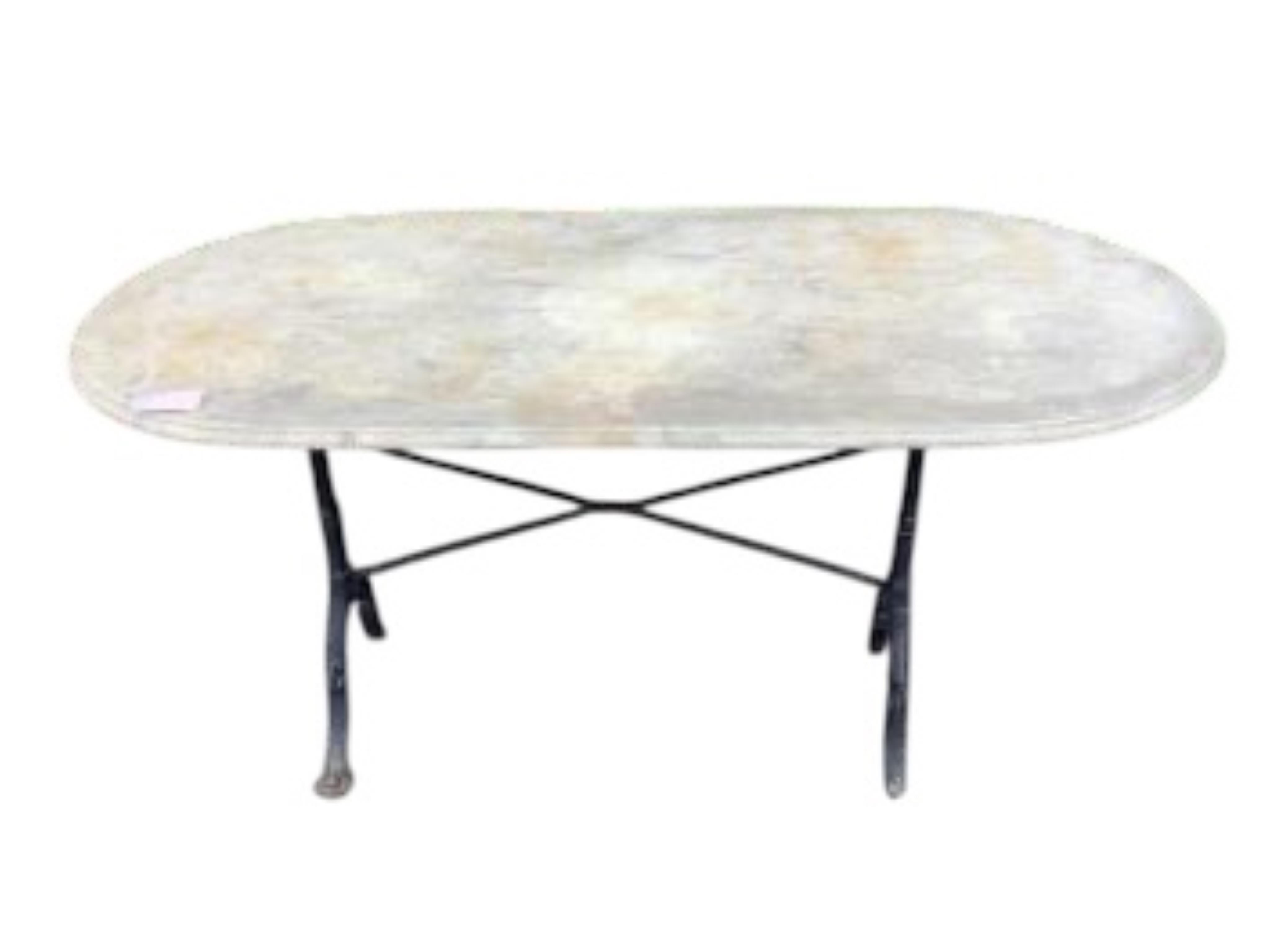An oval reconstituted marble and wrought iron garden table, width 135cm, depth 69cm, height 70cm